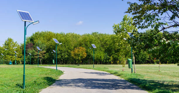 Park alley illuminated by solar powered street lights in Tineretului Park, Bucharest, Romania